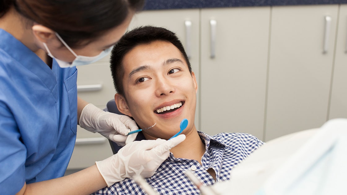 Pointing to the temporomandibular joint (TMJ) on a model school